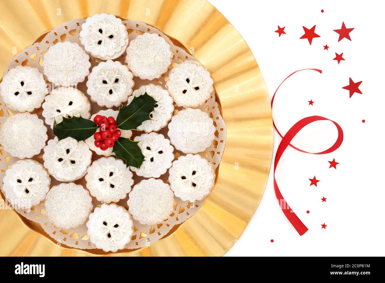Traditional mince pies for Christmas on a gold plate with holly on a ...