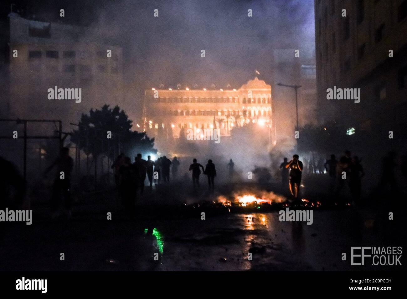 Beirut, Lebanon, 11 June 2020. People run from the Lebanese Army out side parliament, during heavy rioting in Beirut and across Lebanon, following 25% depreciation of the Lebanese pound in 48 hours. Stock Photo