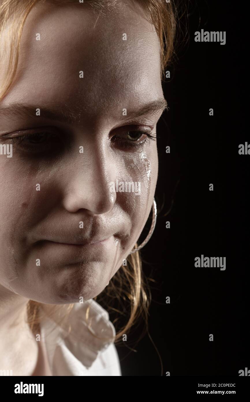 sad woman crying, looking aside on black background, closeup portrait,  profile view Stock Photo - Alamy