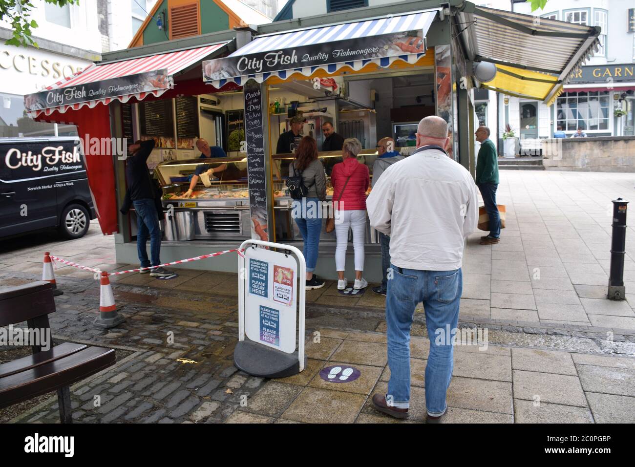 Social distancing measures in operation in Norwich market during Coronavirus lockdown, UK June 2020. Fish stall Stock Photo
