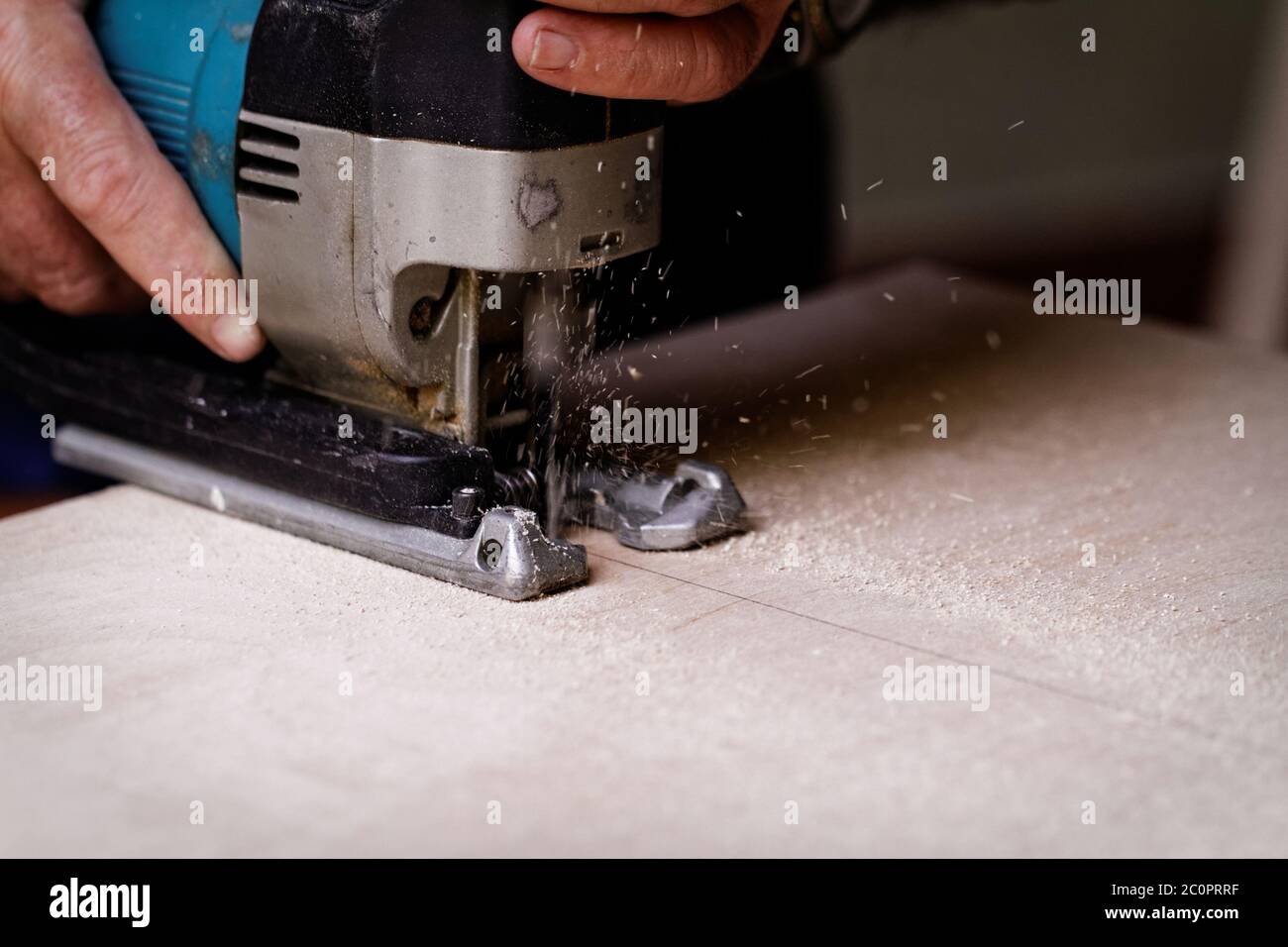 Photo of a man working with fret saw Stock Photo