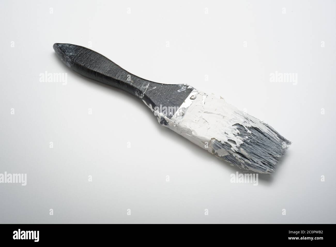 An old paint hardened paintbrush. A brush that has been left uncleaned