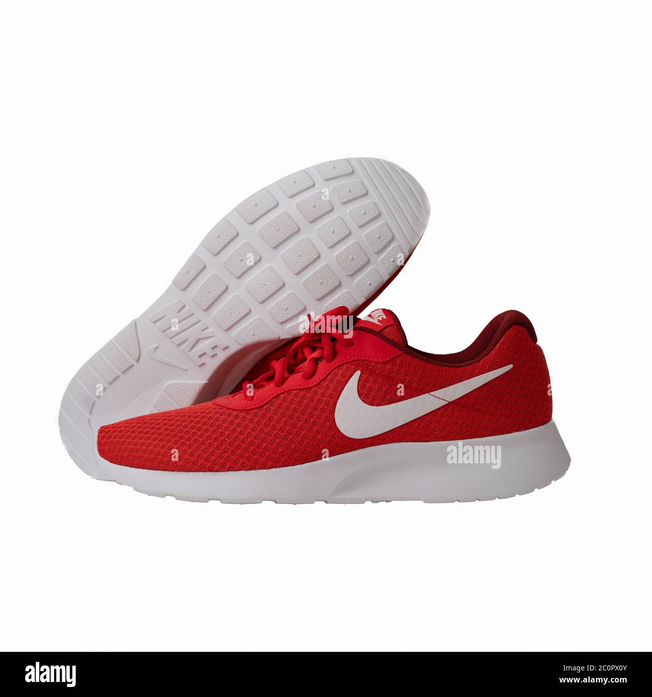 Red Nike brand sneakers. Popular lightweight shoes model lace-up model for  fitness and jogging with red top and white sole. Cut out on white Stock  Photo - Alamy