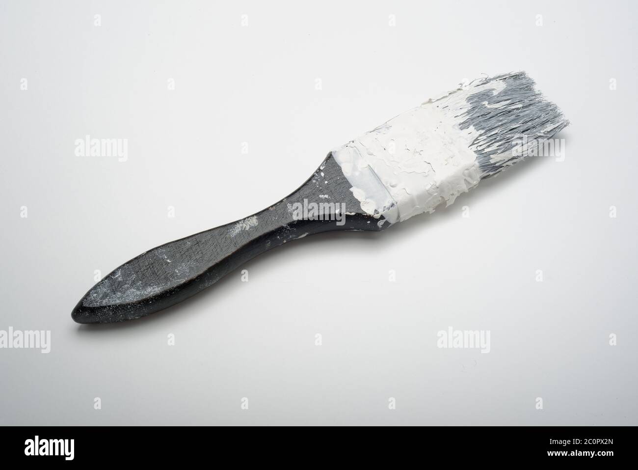 An old paint hardened paintbrush. A brush that has been left uncleaned