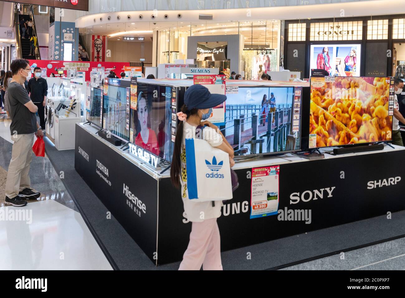 Shoppers look at different television QLED screen brands at a showroom in Hong Kong. Stock Photo