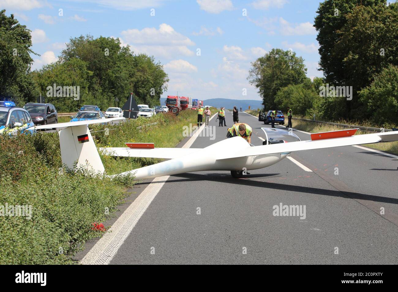 Miltenberg, Germany. 12th June, 2020. A glider is parked on the Bundesstraße 469. 67-year-old pilot was seriously injured in the emergency landing. He had taken off with his plane from an airfield in Aschaffenburg and had been towed up to the height by a motorized aircraft. Technical problems had occurred with the motorised aircraft, so that the glider had to be released earlier than intended and had not reached the necessary flying altitude. The pilot had therefore decided to make an emergency landing. Credit: Ralf Hettler/dpa/Alamy Live News Stock Photo