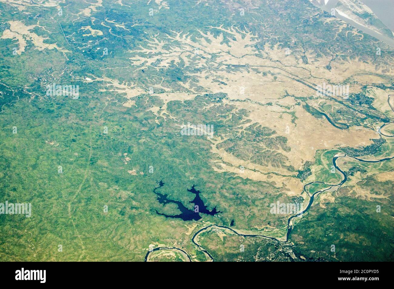 Aerial view of the geographical features west of the town of Thayet in Myanmar including a deep lake and a tributary of the Irrawaddy River. Stock Photo
