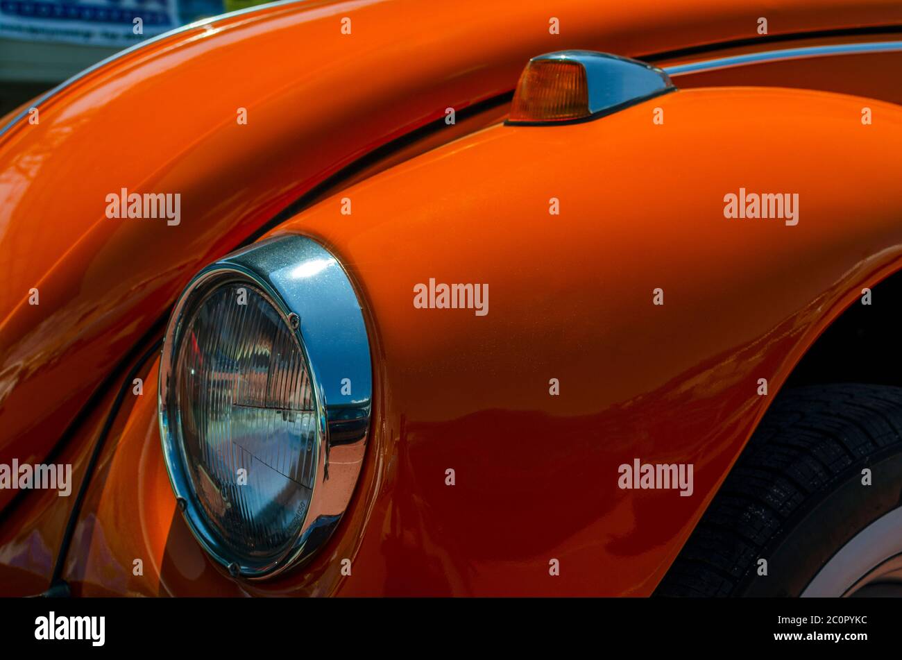 Heraklion, Crete / Greece. Close up detailed view of the front fender with the headlight and the turn signal light of an orange Volkswagen Beetle Stock Photo