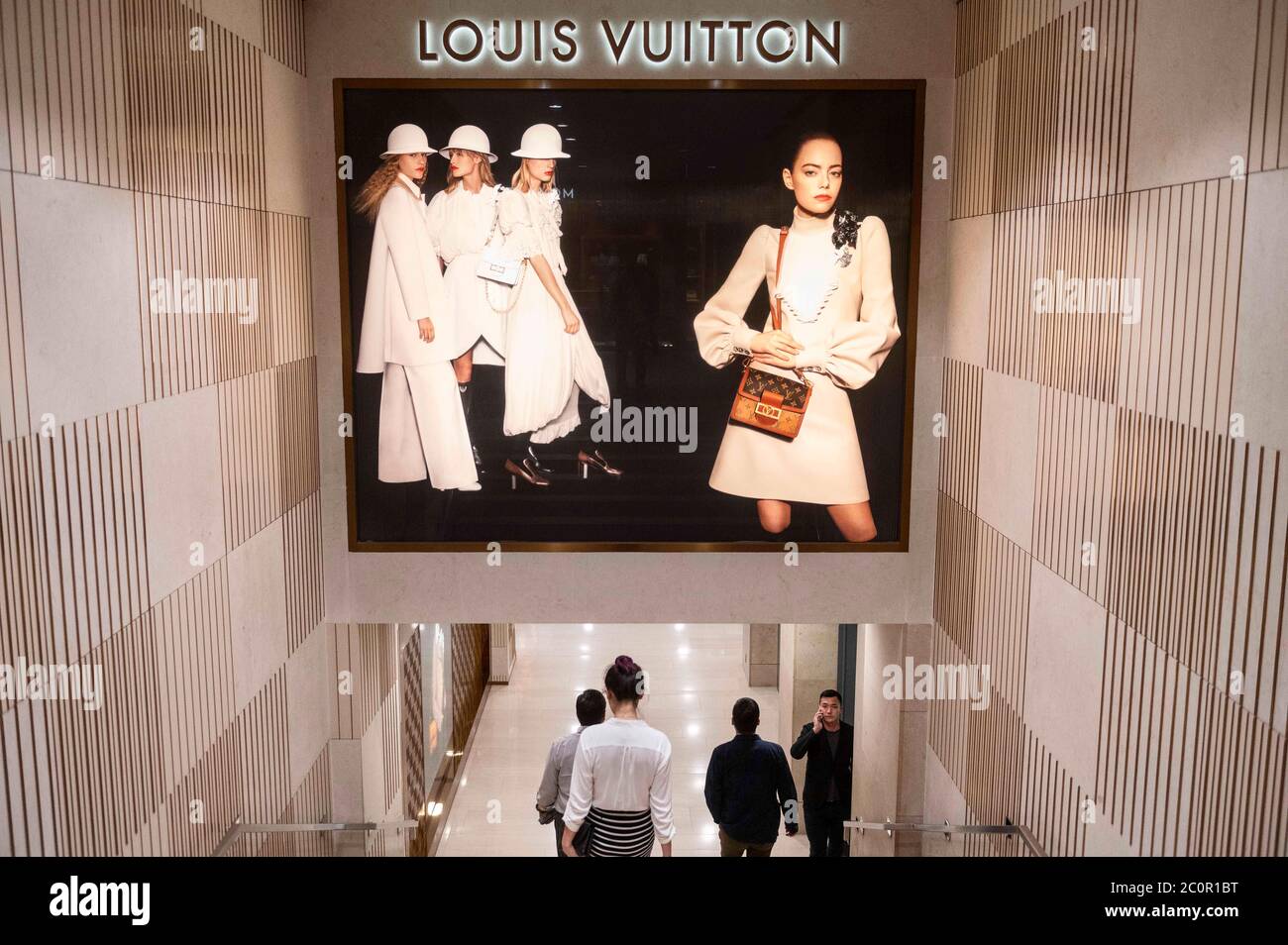 Hong Kong, China. 9th June, 2020. Commuters walk past a commercial  advertisement of the French luxury fashion brand Louis Vuitton store seen  in Hong Kong. Credit: Budrul Chukrut/SOPA Images/ZUMA Wire/Alamy Live News