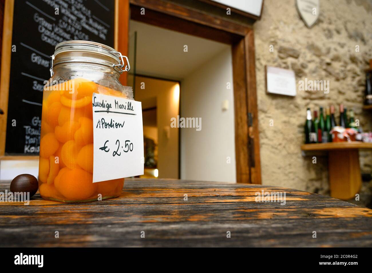 A jar of apricots sits outside a small shop in the town of Dürnstein in the Wachau Valley wine region of Austria Stock Photo