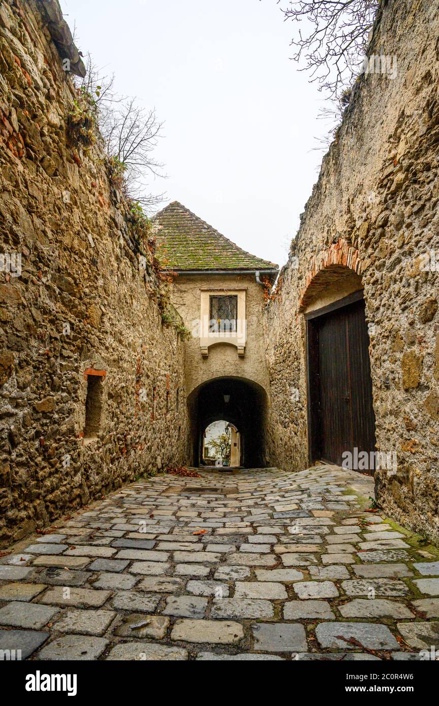 A cobbled path between stone walls in the UNESCO World Heritage-listed town of Dürnstein in Wachau Valley, Austria Stock Photo