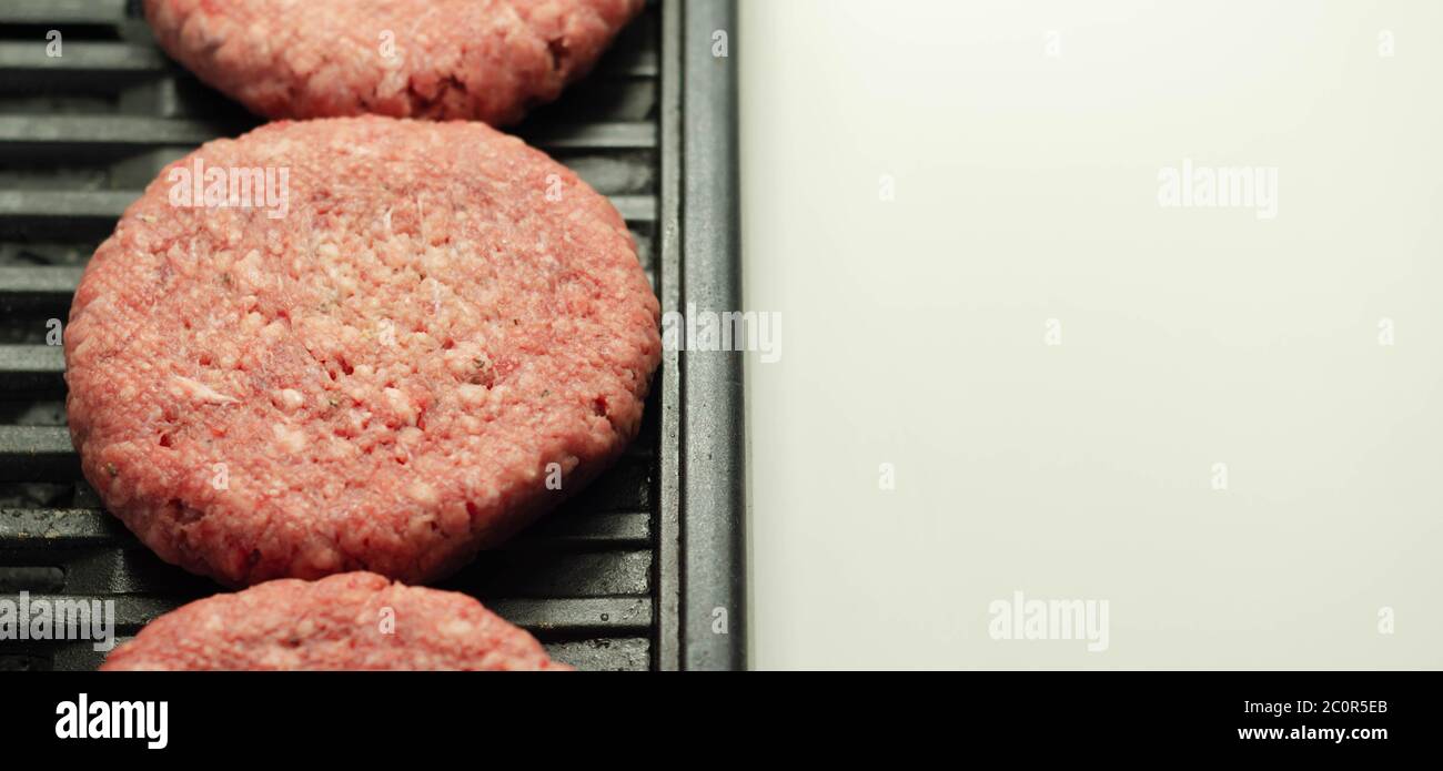 Seasoned beef burgers with a pinch of salt and black pepper on the