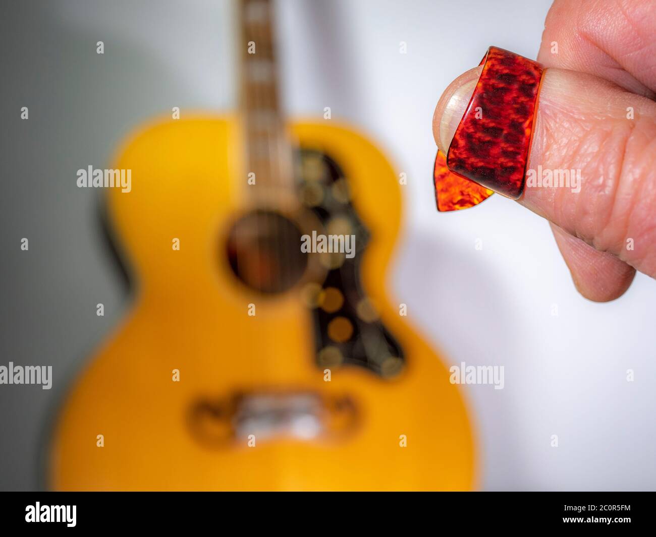 Closeup of a man s thumb wearing a plastic tortoiseshell patterned