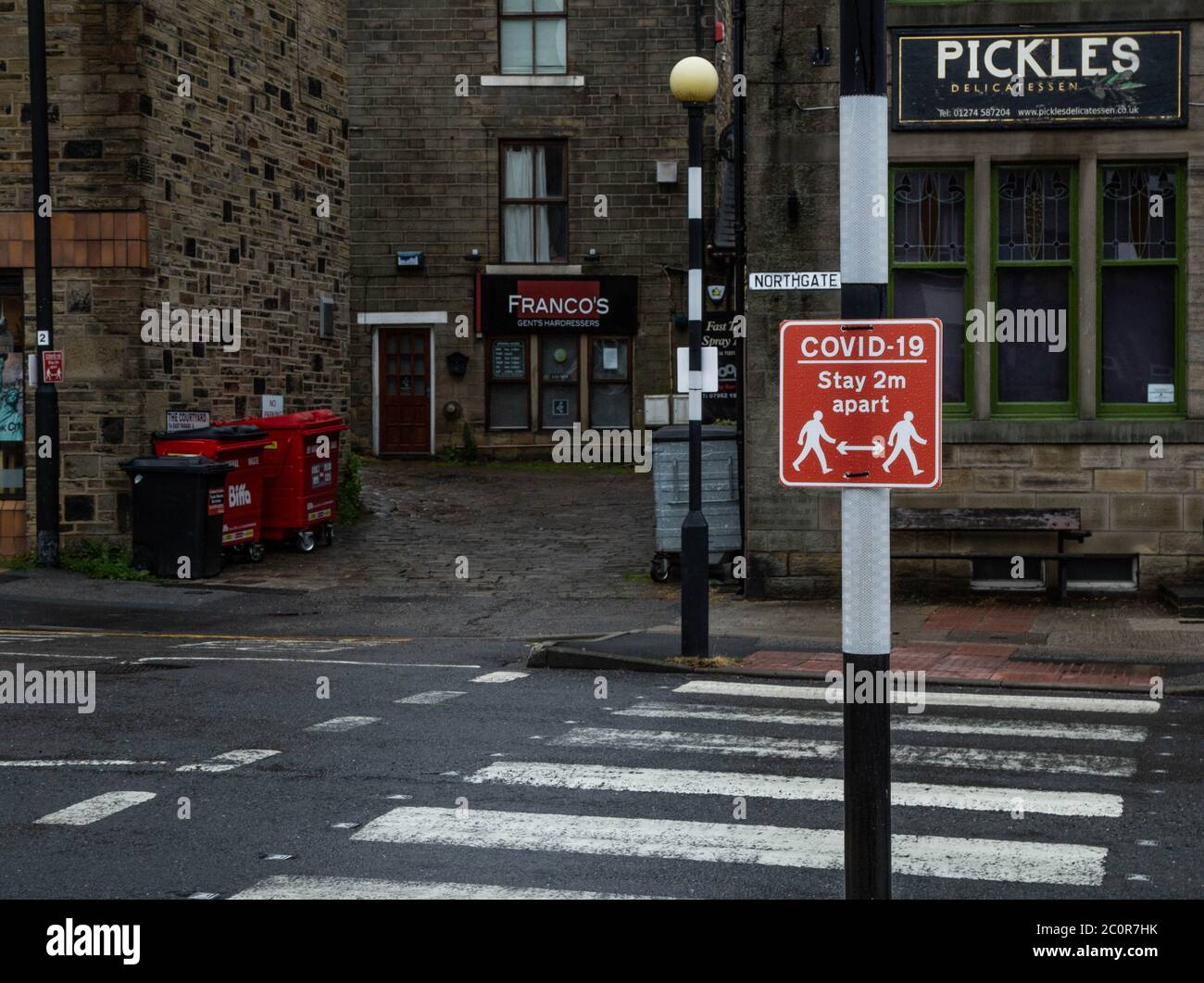 Covid-19 signs in Baildon, Yorkshire, warning people to walk 2 metres apart. Stock Photo