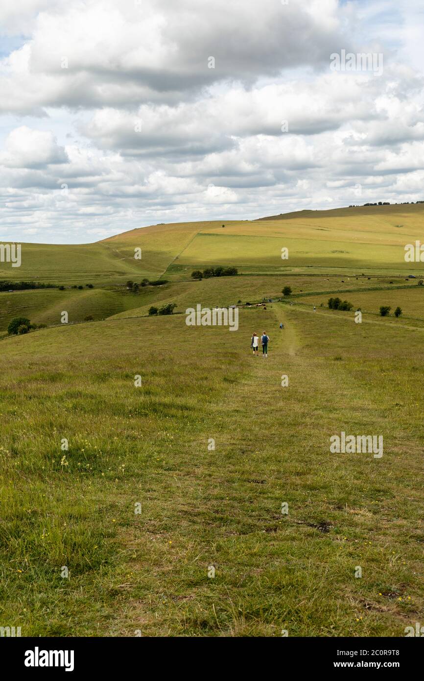 Walkers on Knap Hill on the Pewsey Downs, Wiltshire, England, UK Stock Photo