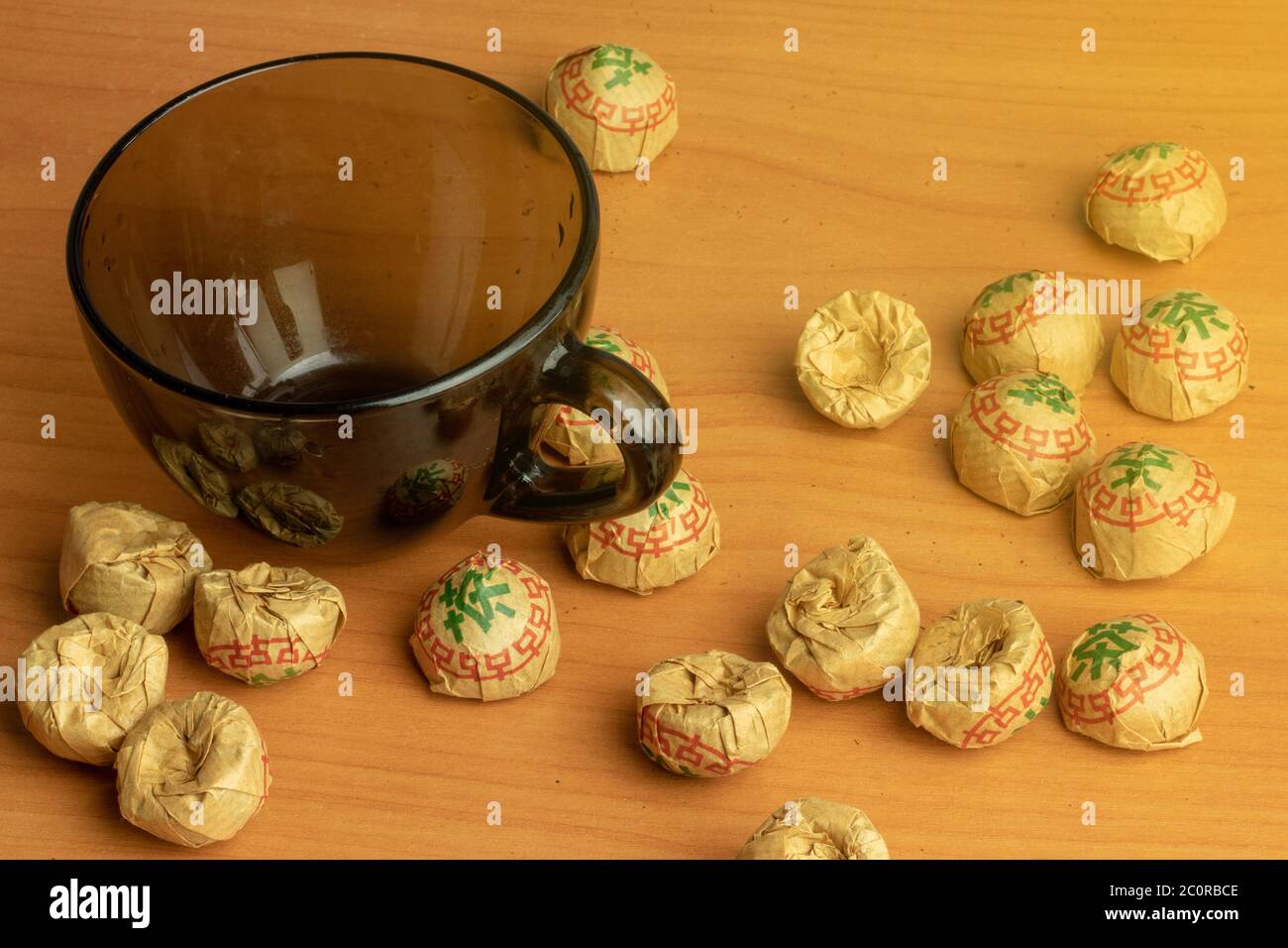 Tea packs with small cup top view. Chinese traditional herbal tea puer. Tea time concept. Stock Photo