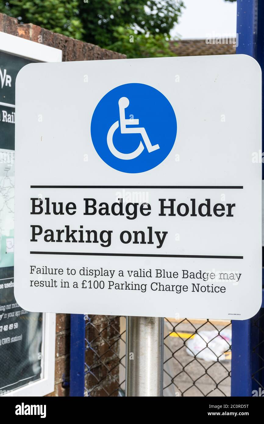 Blue badge holder parking only sign at a railway station, car park