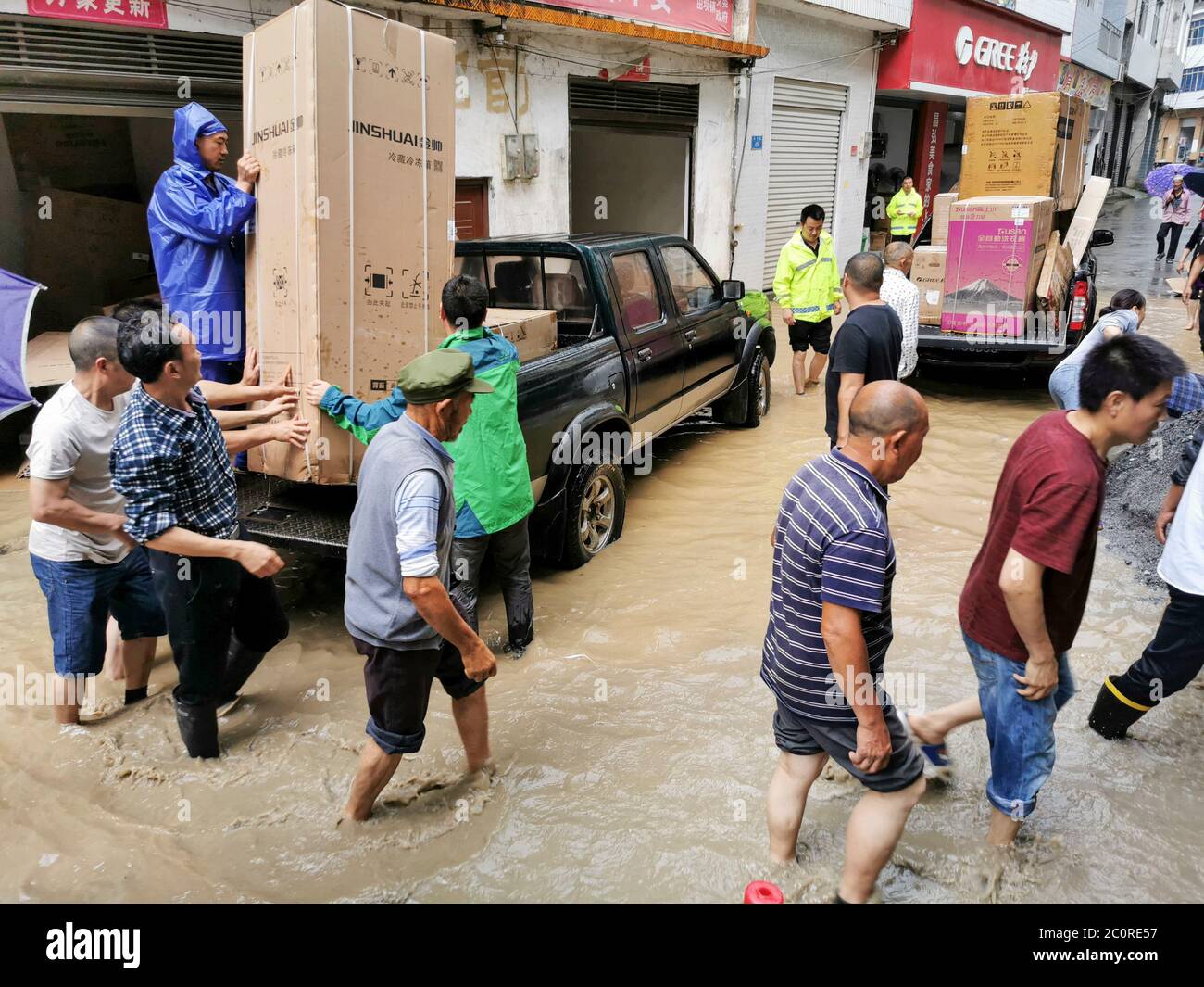 Chongqing, China's Chongqing. 12th June, 2020. Staff members of local government transfer flood-affected residents at Tianba Town in Wuxi County, southwest China's Chongqing, June 12, 2020. Vehement rainstorms have claimed one life while four others are missing in southwest China's Chongqing Municipality, local authorities confirmed Friday. Credit: Wen Shiyi/Xinhua/Alamy Live News Stock Photo