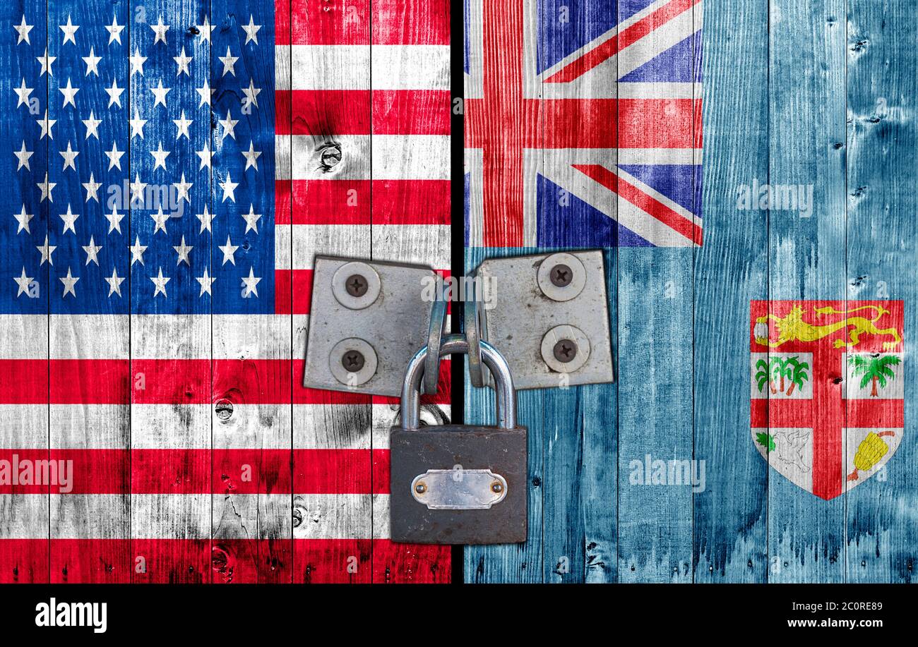 US and  Fiji flag on door with padlock Stock Photo