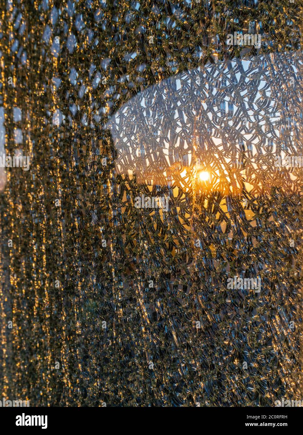 burning sunset reflects in the broken glass Stock Photo Alamy