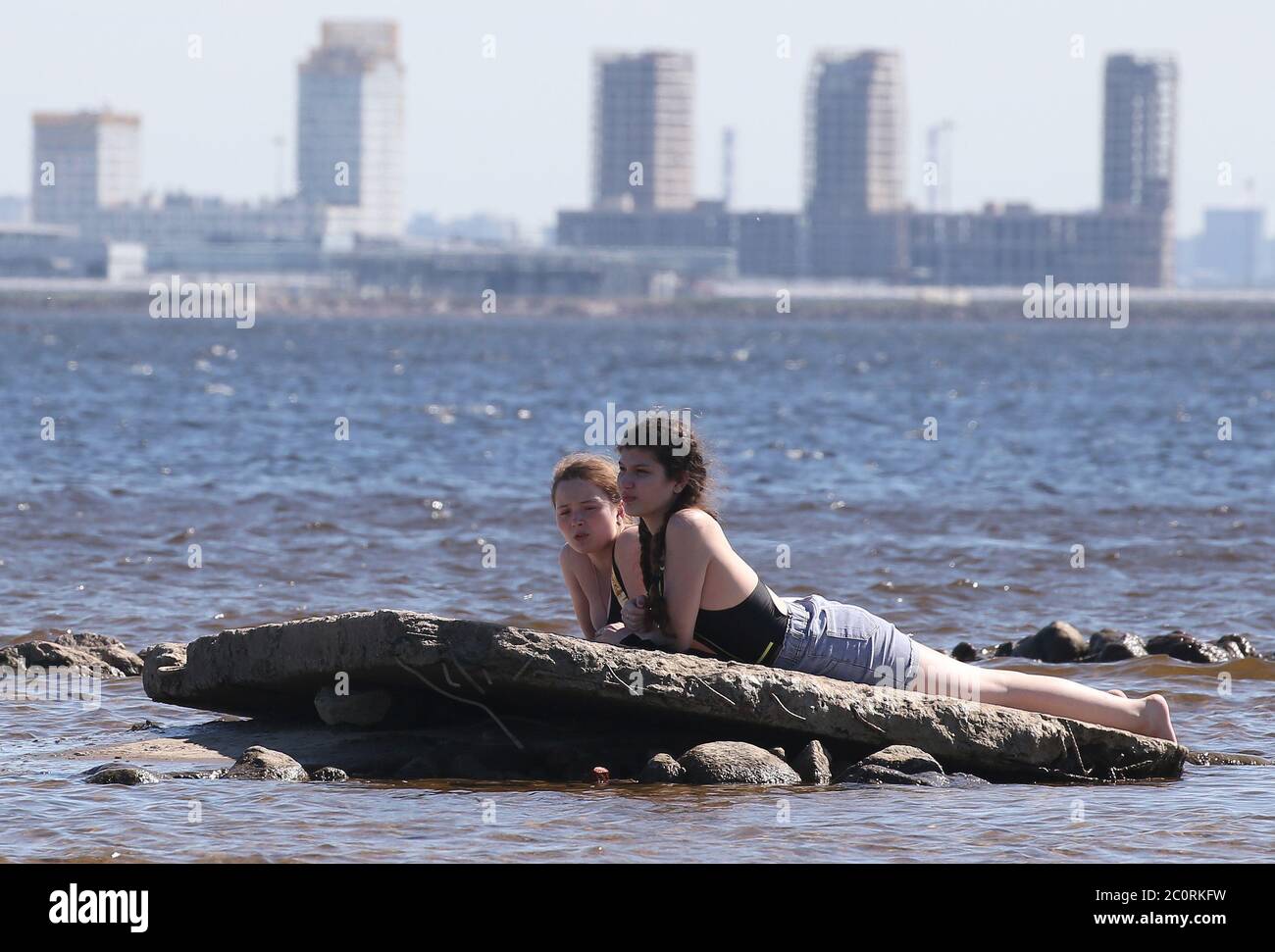 St Petersburg Russia 12th June Girls Are Sunbathing On A Concrete Slab On The Shore Of The Gulf Of Finland During A National Holiday Known As Russia Day Celebrated On 12