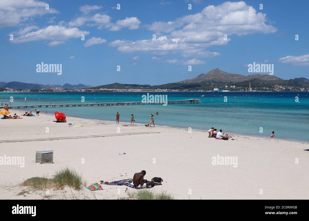 Mallorca, Spain. 12th June, 2020. People enjoy the beach de Muro. Mallorca is preparing for the new summer season. With up to 10,900 holidaymakers from Germany, the Balearic Islands will gradually be opened to the public from 15 June. Credit: Clara Margais/dpa/Alamy Live News Stock Photo