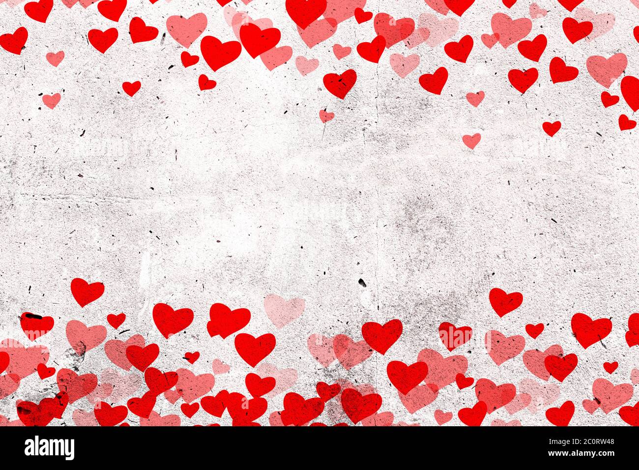 Valentines Day background, Love concept, Red Hearts on white concrete grunge wall background with copy space in the middle of the wall Stock Photo