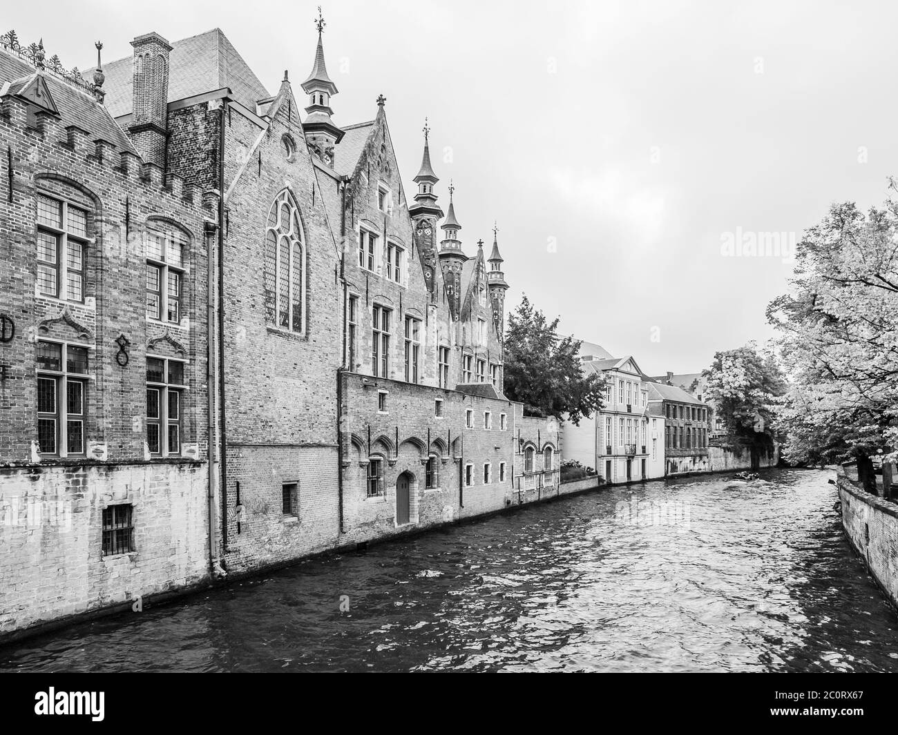 Old brick houses along water canals in Bruges, Belgium. Black and white
