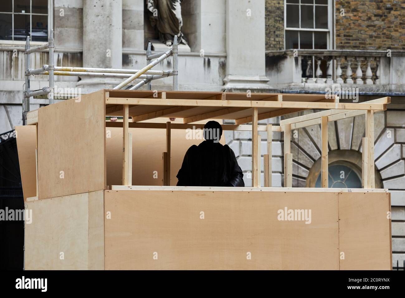 London, UK. - 12 Jun 2020: The statue of Thomas Guy being boarded up prior to removal from its position in a courtyard of the hospital he helped found. Thomas Guy is said to have made his fortune from shares in a company that was involved in the slave trade. Stock Photo