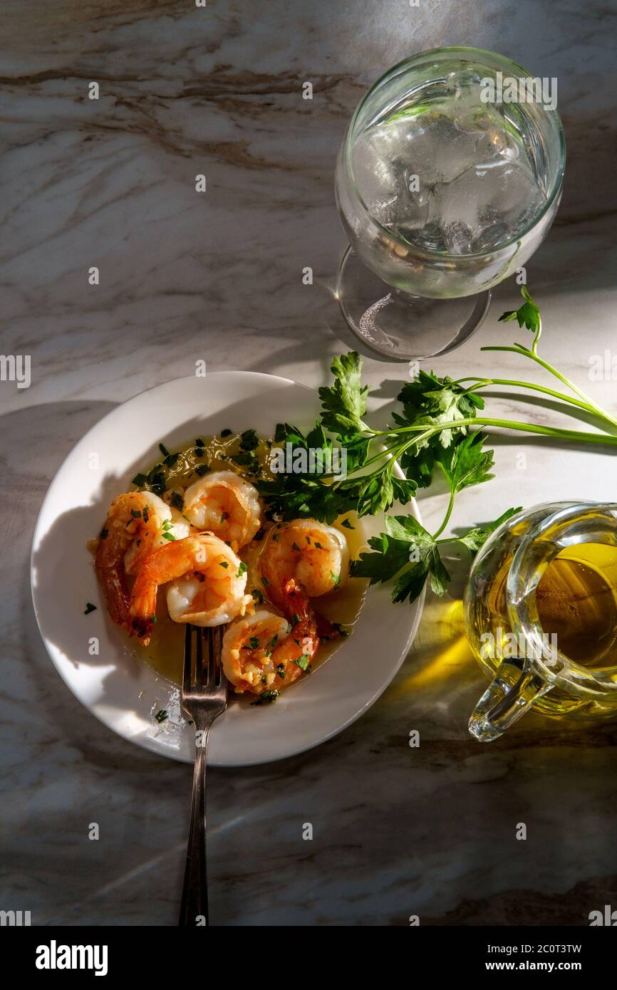 Portuguese dinner camarao ao alho e oleo garlic shrimp with dramatic sunlight Stock Photo
