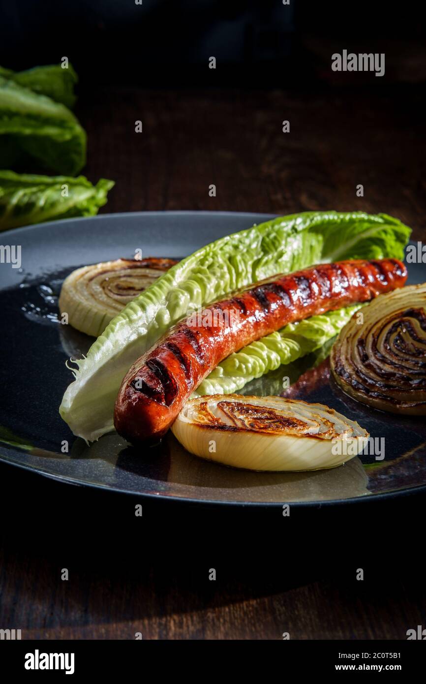 Fancy gourmet glutenfree lettuce wrap hot dog with grill marks and