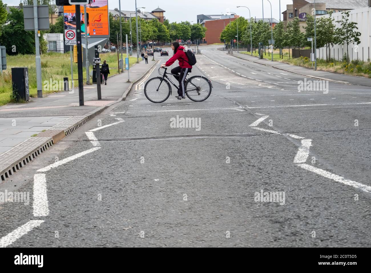 Glasgow, Scotland, UK. 12th June, 2020. A cyclist crosses Crown Street at traffic lights. The Scottish Government announced on 28th May an easing of the coronavirus lockdown rules at the start of phase one of a four part transition out of lockdown. Credit: Skully/Alamy Live News Stock Photo
