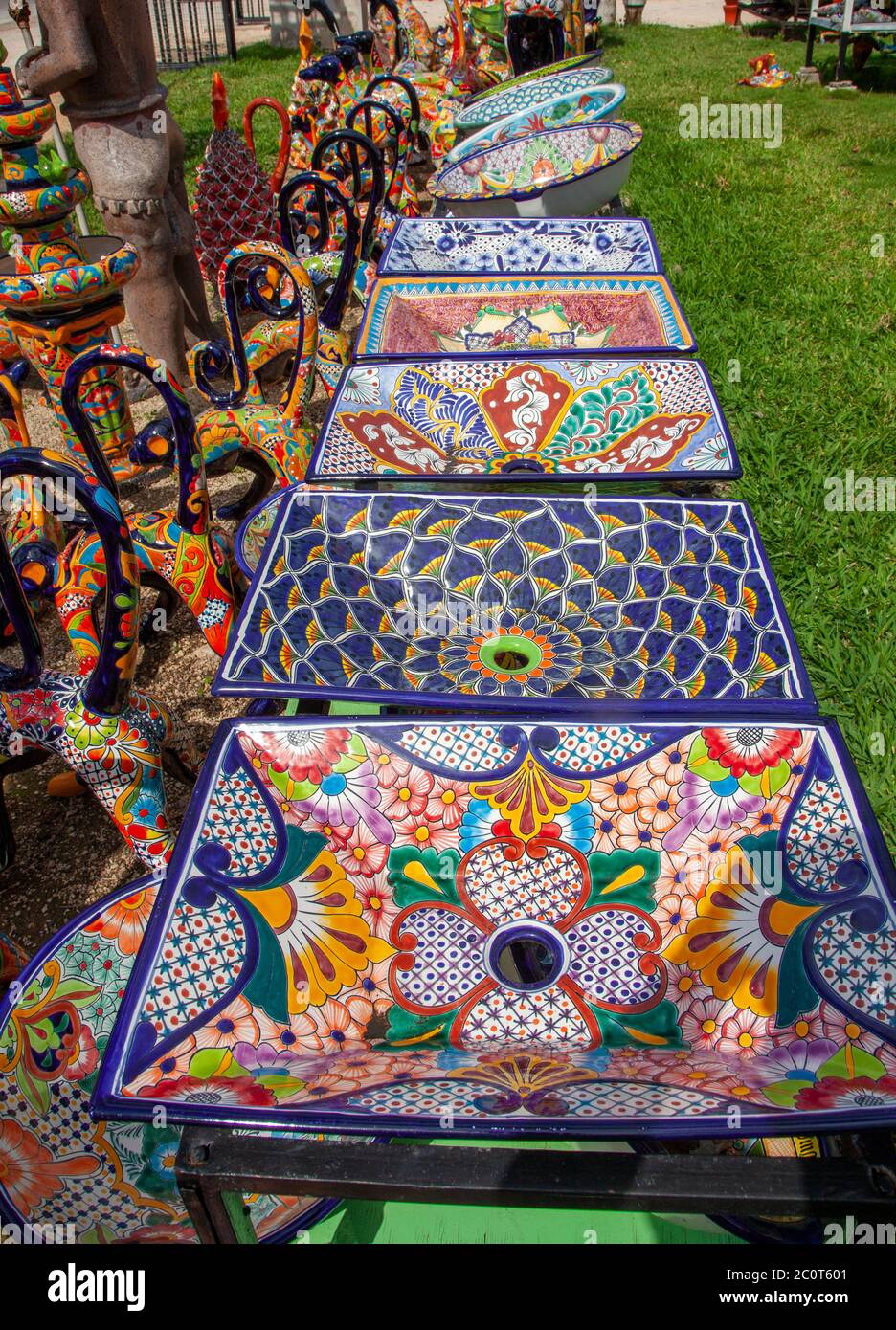 Talavera sinks nudge a collection of Talavera monkeys at Sr.Tequila's Artesanias and Crafts, a tourist stopper on the Tulum-Coba Road in Francisco Uh Stock Photo