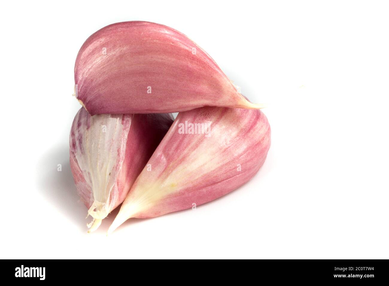 Three garlic cloves isolated on white background Stock Photo - Alamy