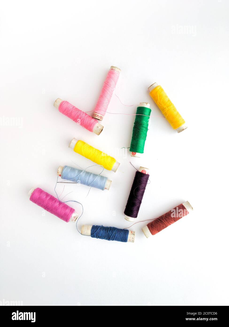 Colourful yarn on spool tube thread isolated image on white background. Stock Photo