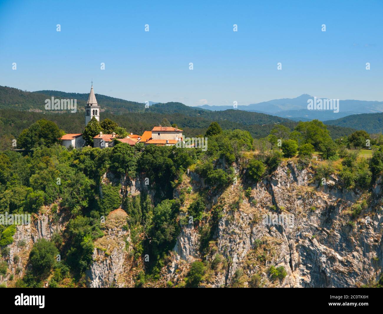 View of deep gorge of Reka River and village with rural church ,Skocjan Caves, Slovenia Stock Photo