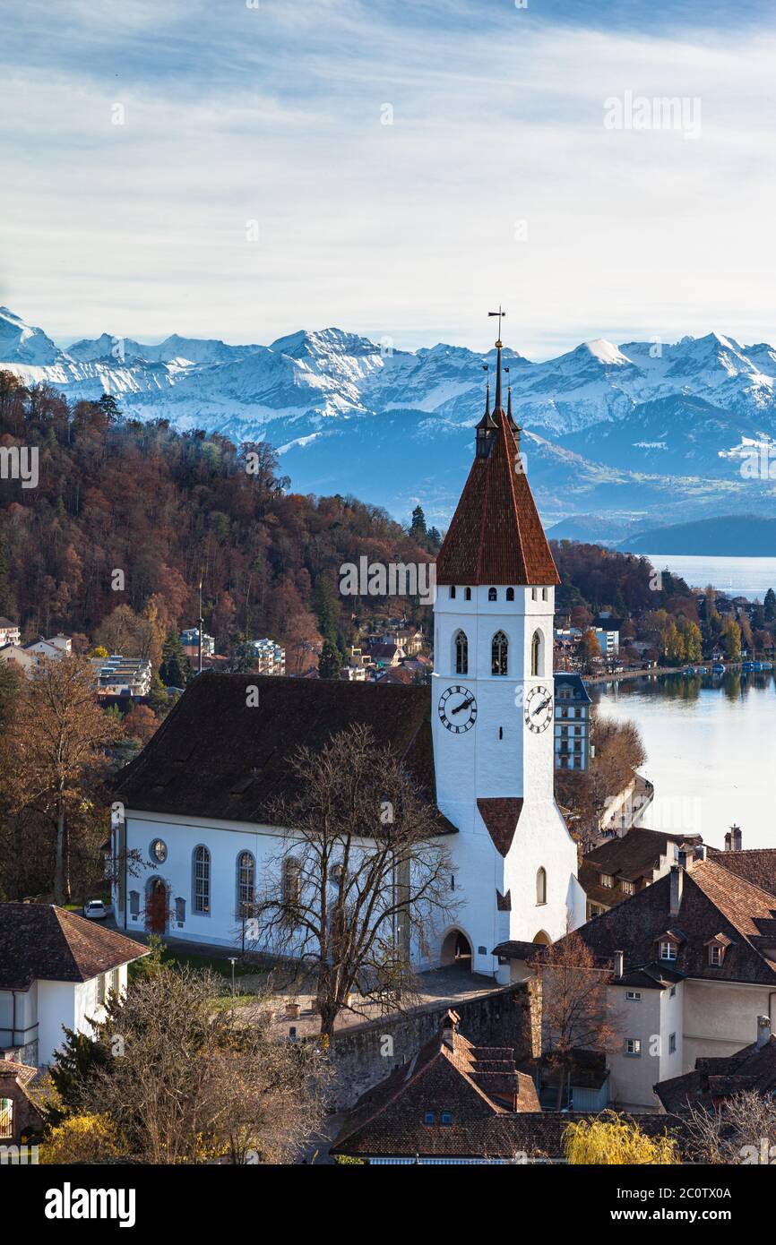 Stunning aerial view of Thun cityscape with Central Church, Aare river flowing to Lake Thun from Thun castle with Swiss Alps peaks on Bernese Oberland Stock Photo