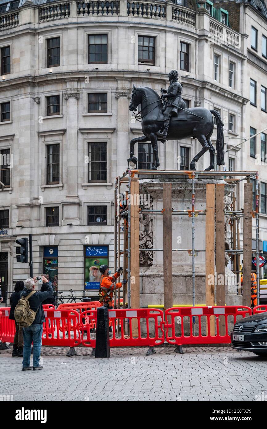 London, UK. 12th June, 2020. The statue of Charles I, is covered up in response to fears that the protests by Black Lives Matter will lead to it being damaged by people climbing on it. It is one of the oldest statues in London. Credit: Guy Bell/Alamy Live News Stock Photo