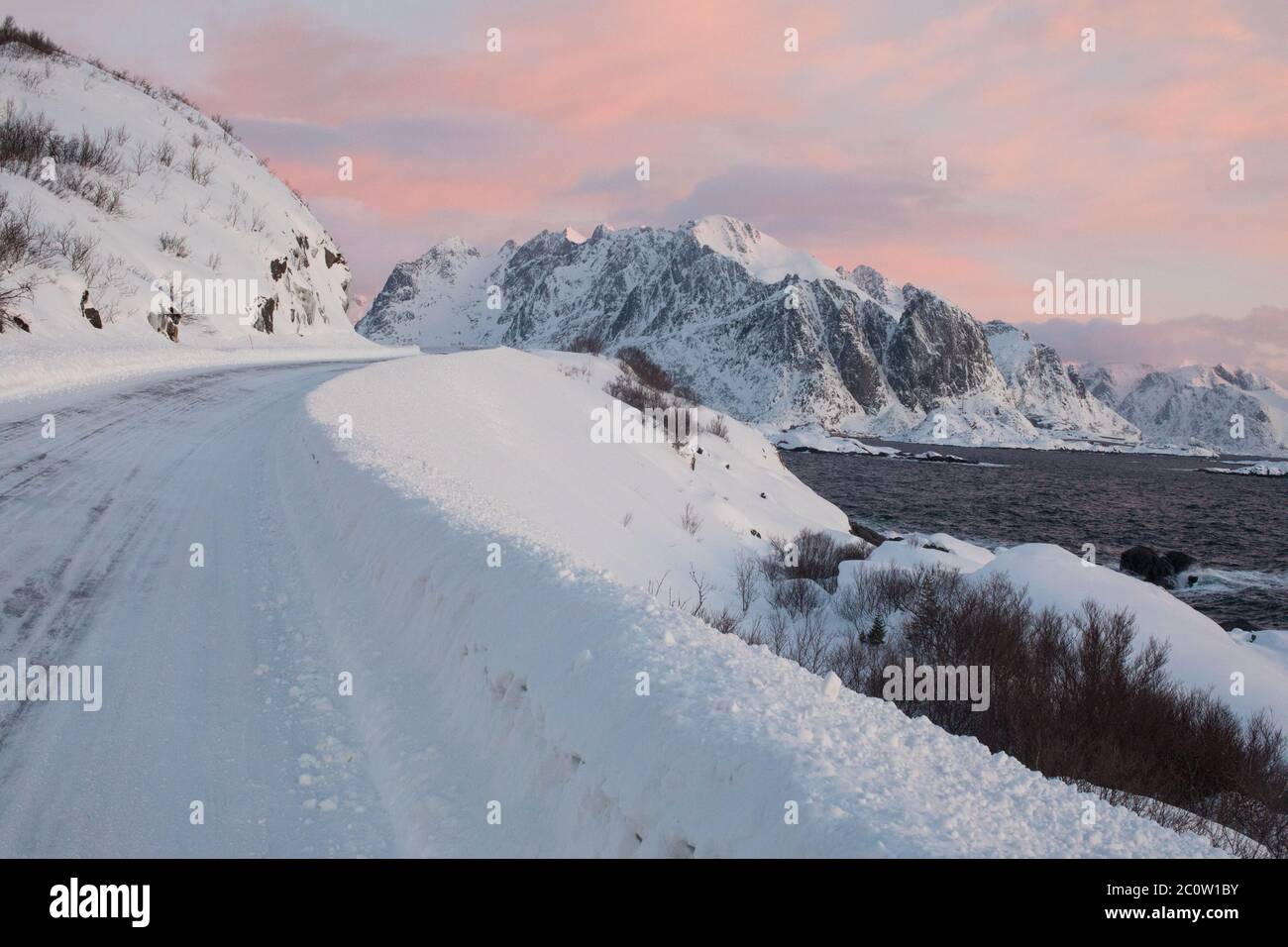 Pink skies and ice mountain roads in Norway. Stock Photo