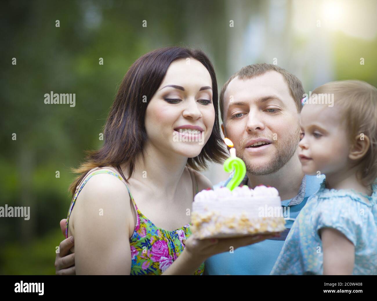 Happy family celebrating second birthday of baby daughter Stock Photo