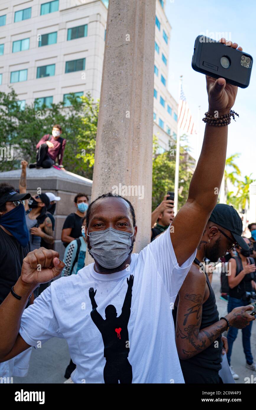 Miami Downtown, FL, USA - MAY 31, 2020: Protests during a coronavirus pandemic. Black man in a protective mask against viruses. US Racial Inequality Stock Photo