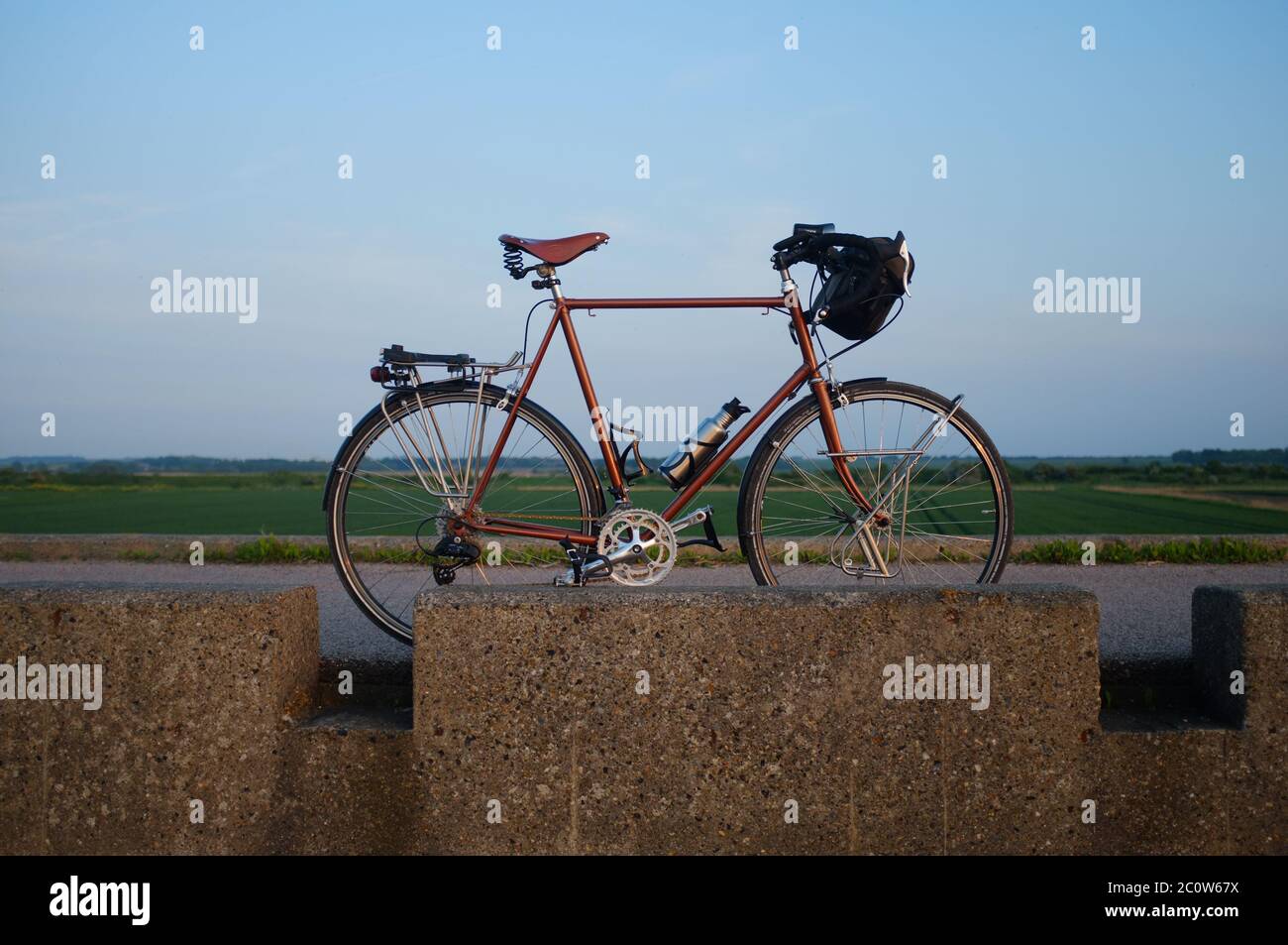Riding bike at sunset during summertime. Stock Photo