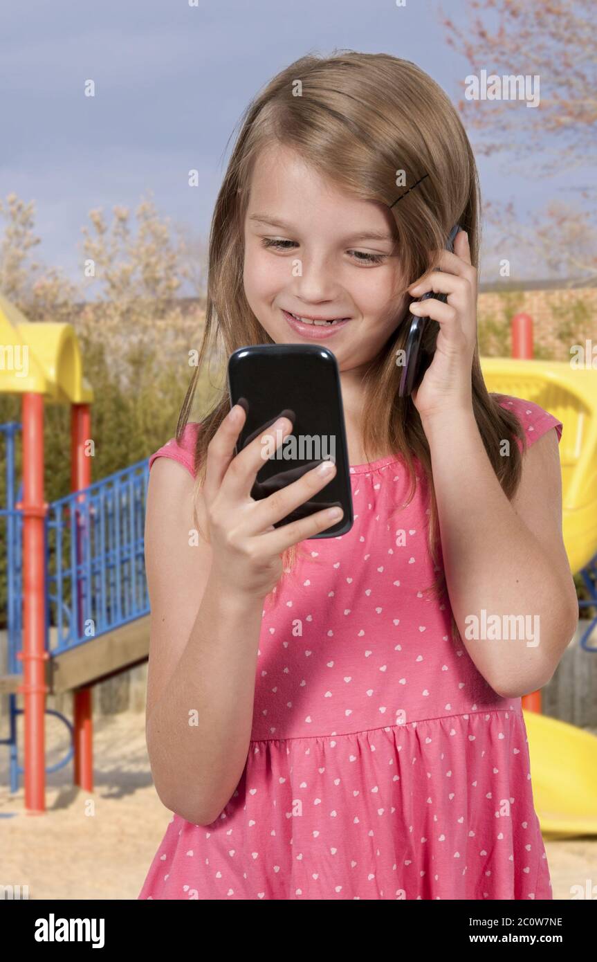 Little Girl Using Cell Phones Stock Photo