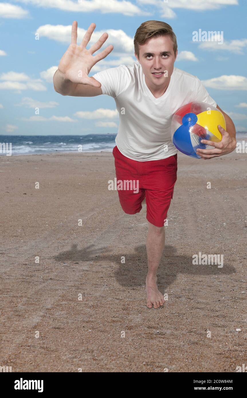 Man Holding Beach Ball Stock Photo