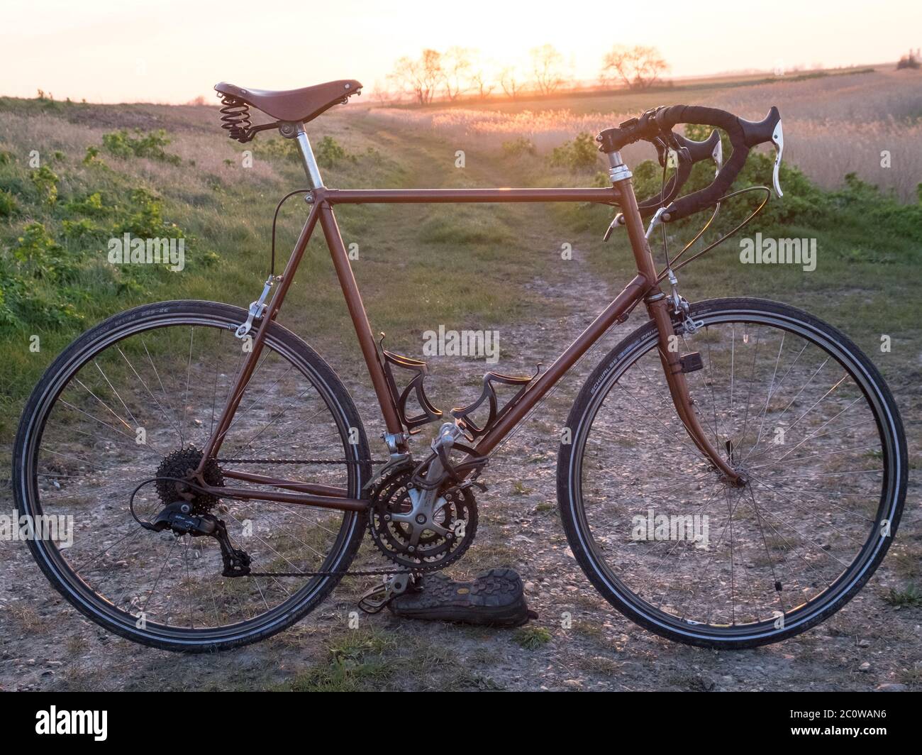 A classic racing bike on a gravel trail in the countryside. Stock Photo