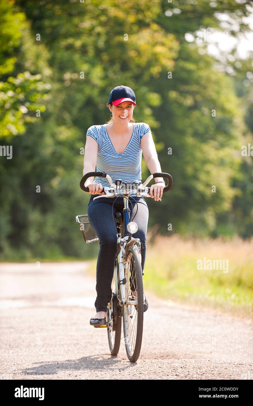 young woman riding a bike Stock Photo