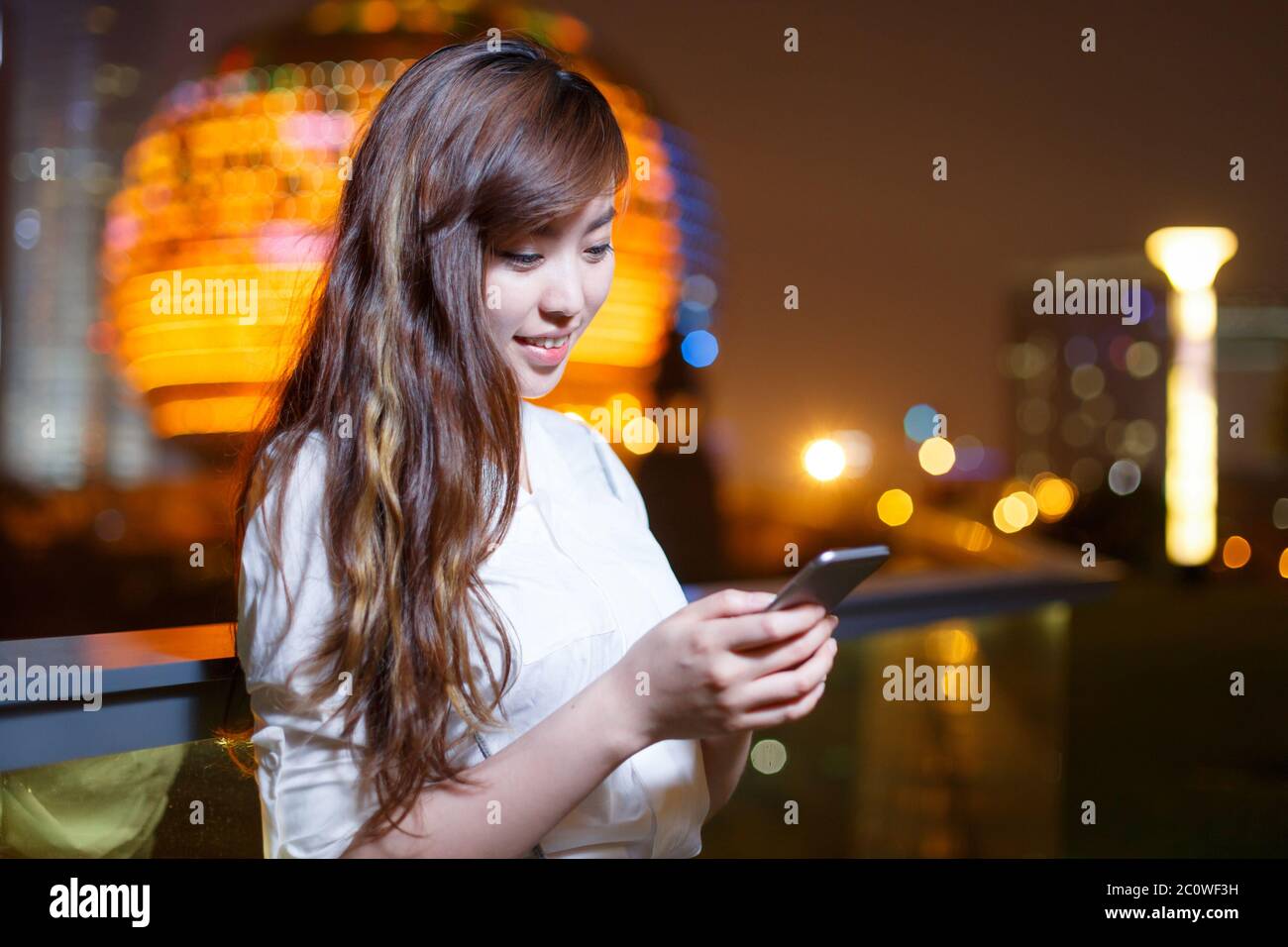 Asian female using smartphone night hi-res stock photography and images ...