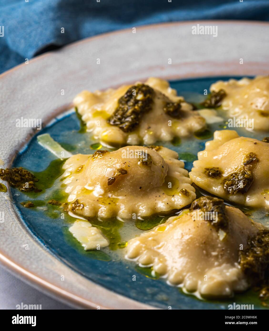 Steamed ravioli filled with squash topped with pesto sauce Stock Photo ...