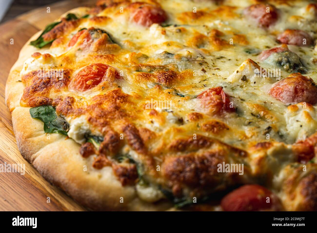 Vegetarian pizza on wooden peel. Stock Photo