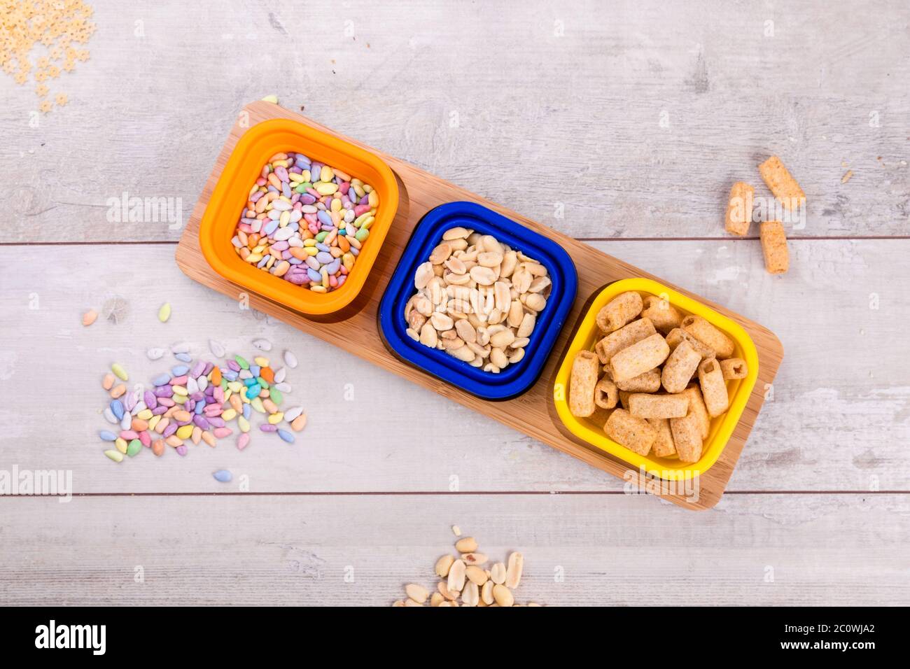 Mix nuts and chips on wooden table, Stock Photo